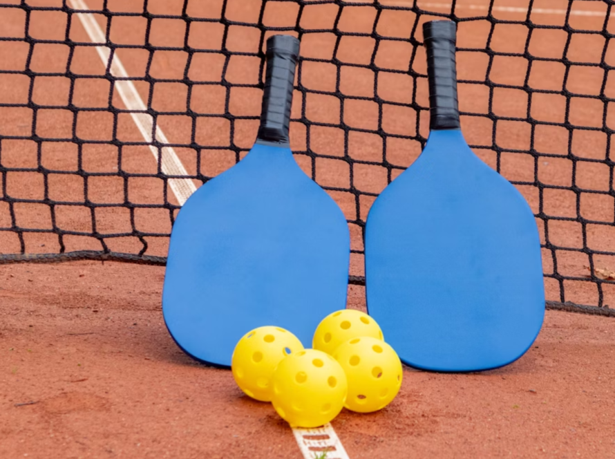 Is it legal to carry or scoop the ball on my paddle?